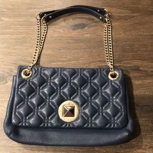 Kate Spade navy blue purse with gold detailing.